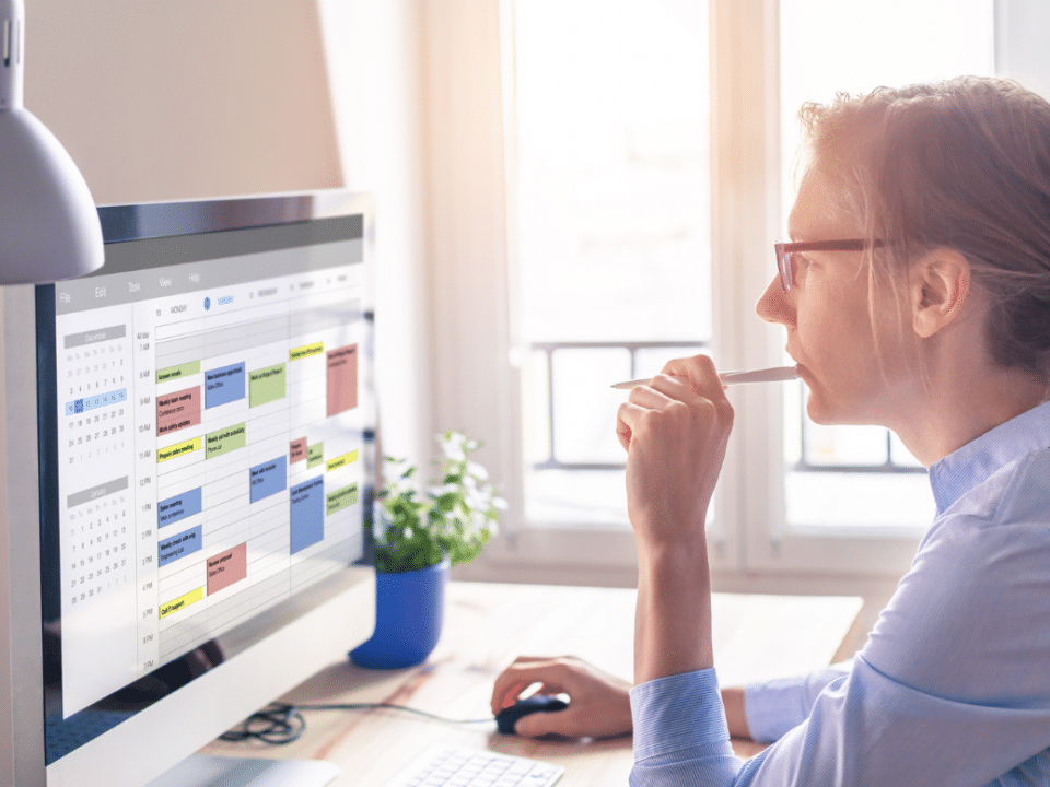 time management: woman looking at schedule on computer