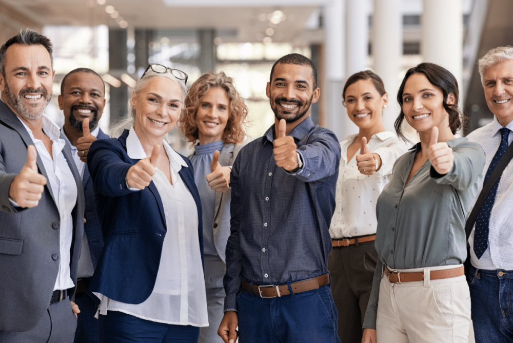 diverse group of professionals giving a thumbs up