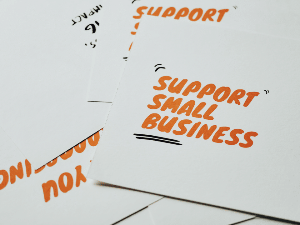 support small business written in orange on post cards