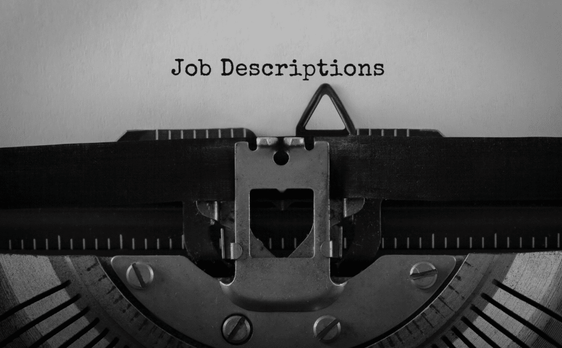 the phrase job descriptions typed out on paper using a typewriter