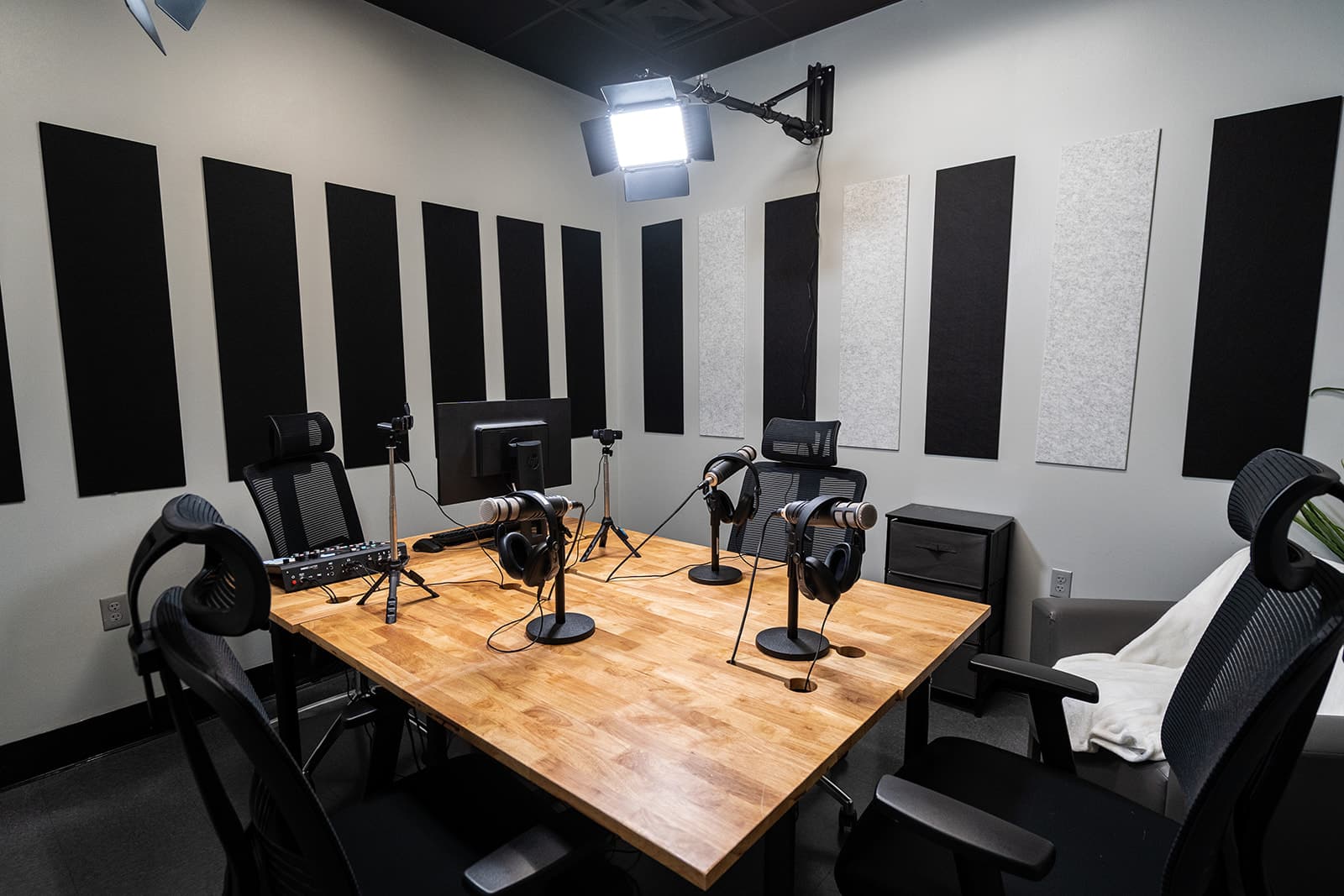 podcast room setup with microphones, cameras, and lights