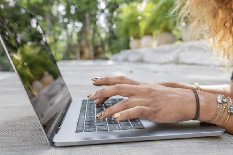 Digital nomad working remotely on laptop.