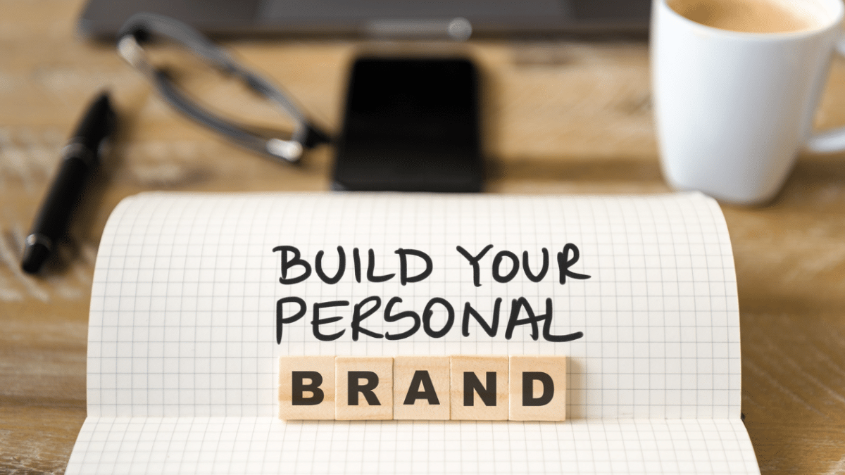 close up of notebook on vintage desk that reads build your personal brand