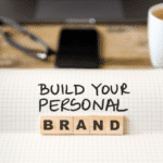 close up of notebook on vintage desk that reads build your personal brand