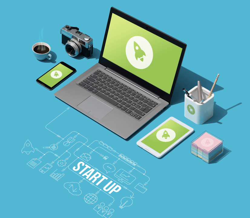 start up concept: laptop surrounded by desk items