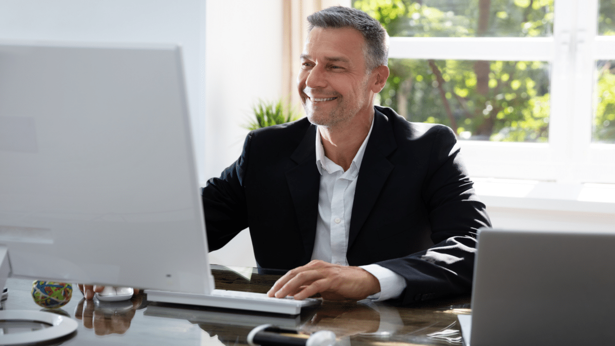 Businessman using his computer to make post-event follow-ups