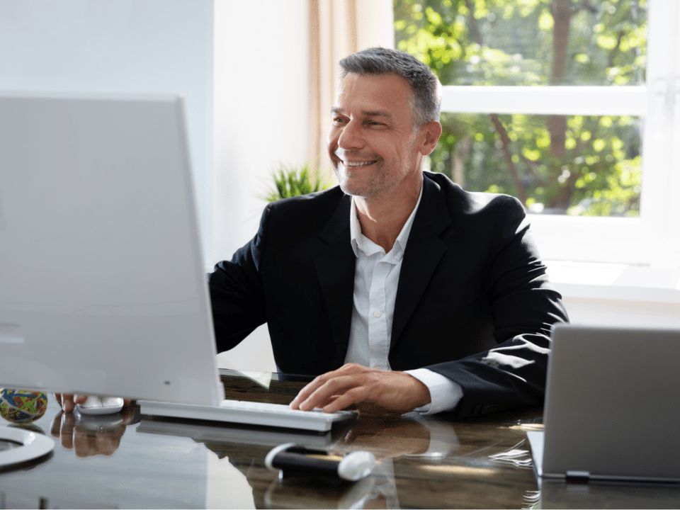 Businessman using his computer to make post-event follow-ups