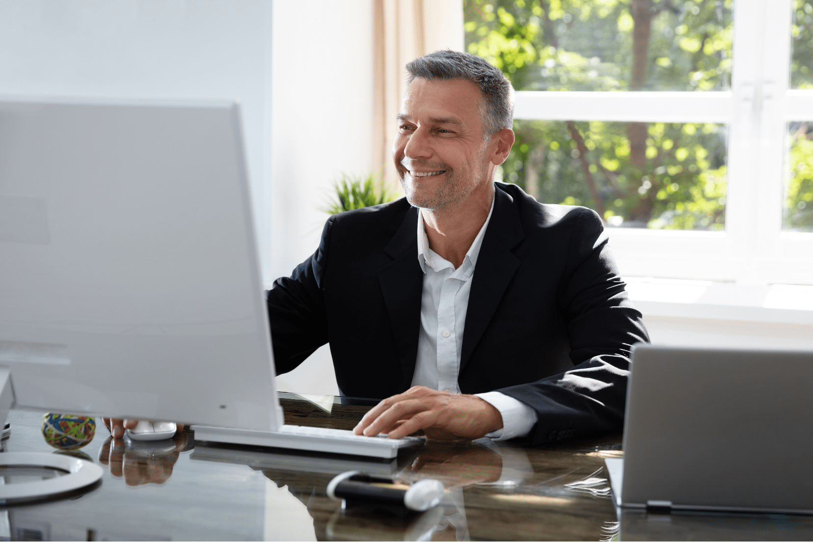 Businessman using his computer to make post-event follow-ups