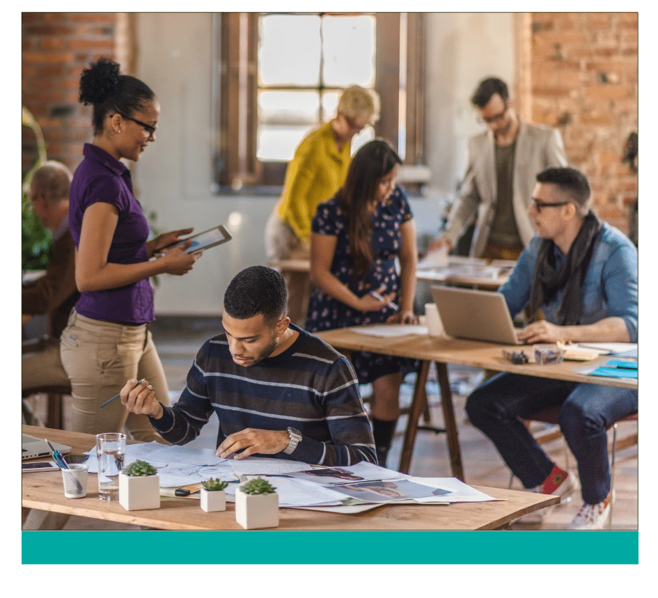 88 ‣ NuvoDesk Coworking Creative office space with diverse professionals collaborating; one person focuses on design plans at a desk, while others engage in discussions and work on laptops and tablets in a modern, open workspace.