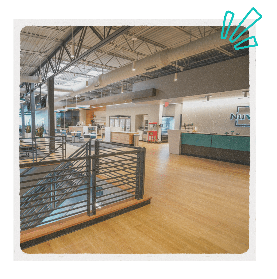 Open, modern coworking space at NuvoDesk featuring a spacious lobby, reception desk, and seating areas for members and guests.