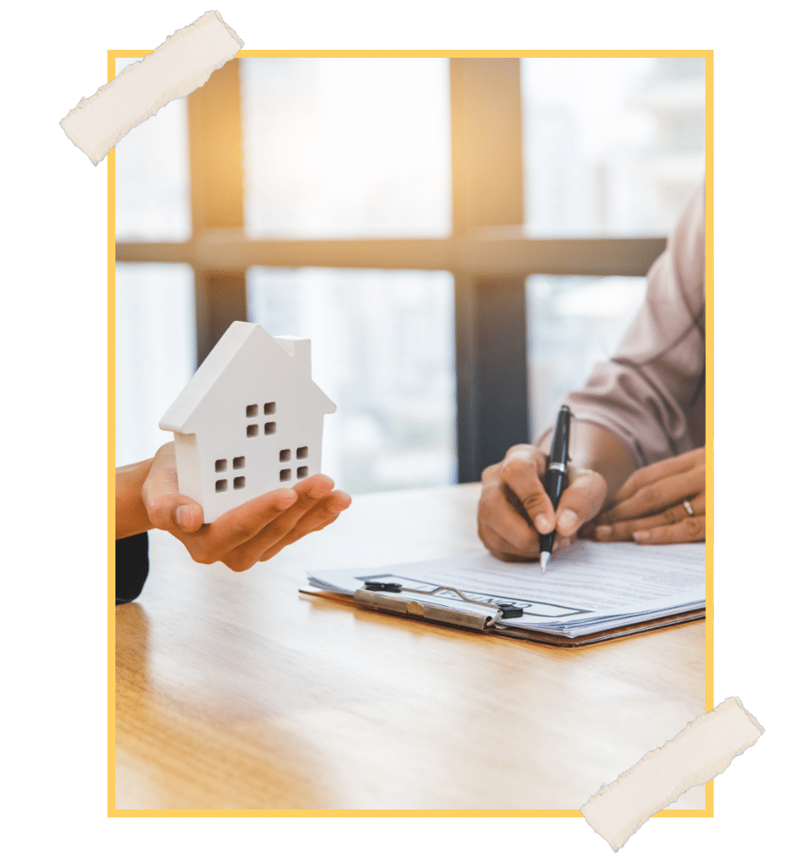 Realtor and client signing a real estate contract while holding a model house NuvoDesk virtual office solutions for real estate agents