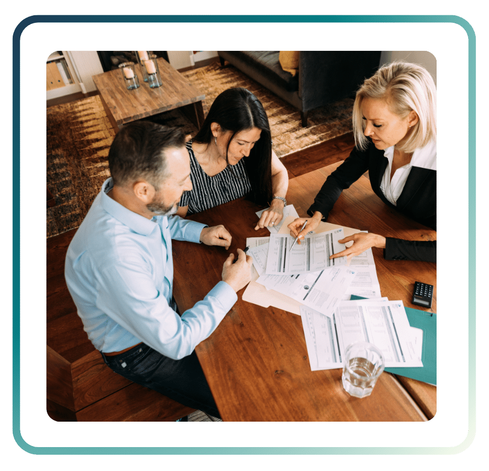 118 ‣ NuvoDesk Coworking Advisor reviewing financial documents with two clients during a business meeting at NuvoDesk coworking space