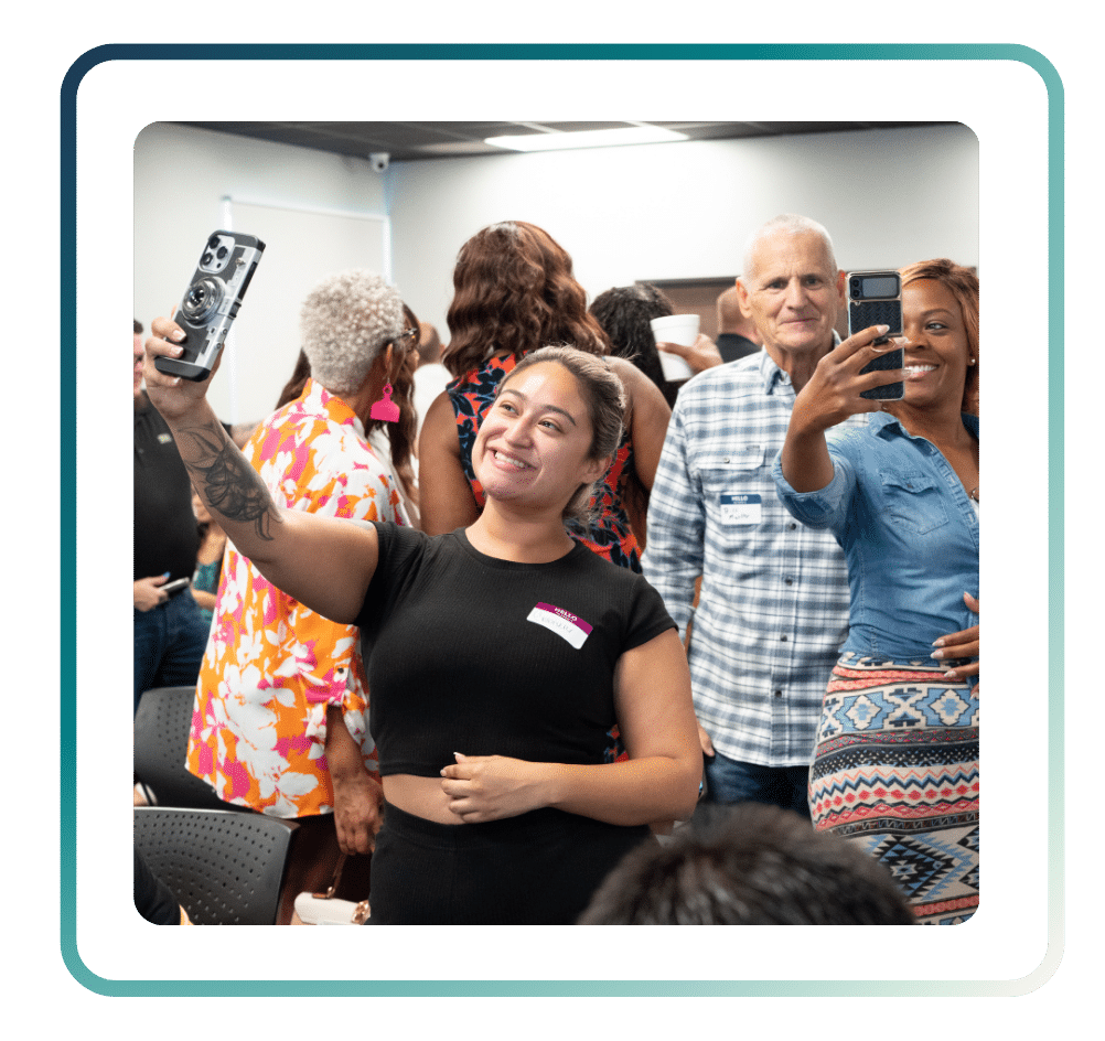 123 ‣ NuvoDesk Coworking Smiling attendees taking selfies and enjoying a NuvoDesk networking event in a lively community setting