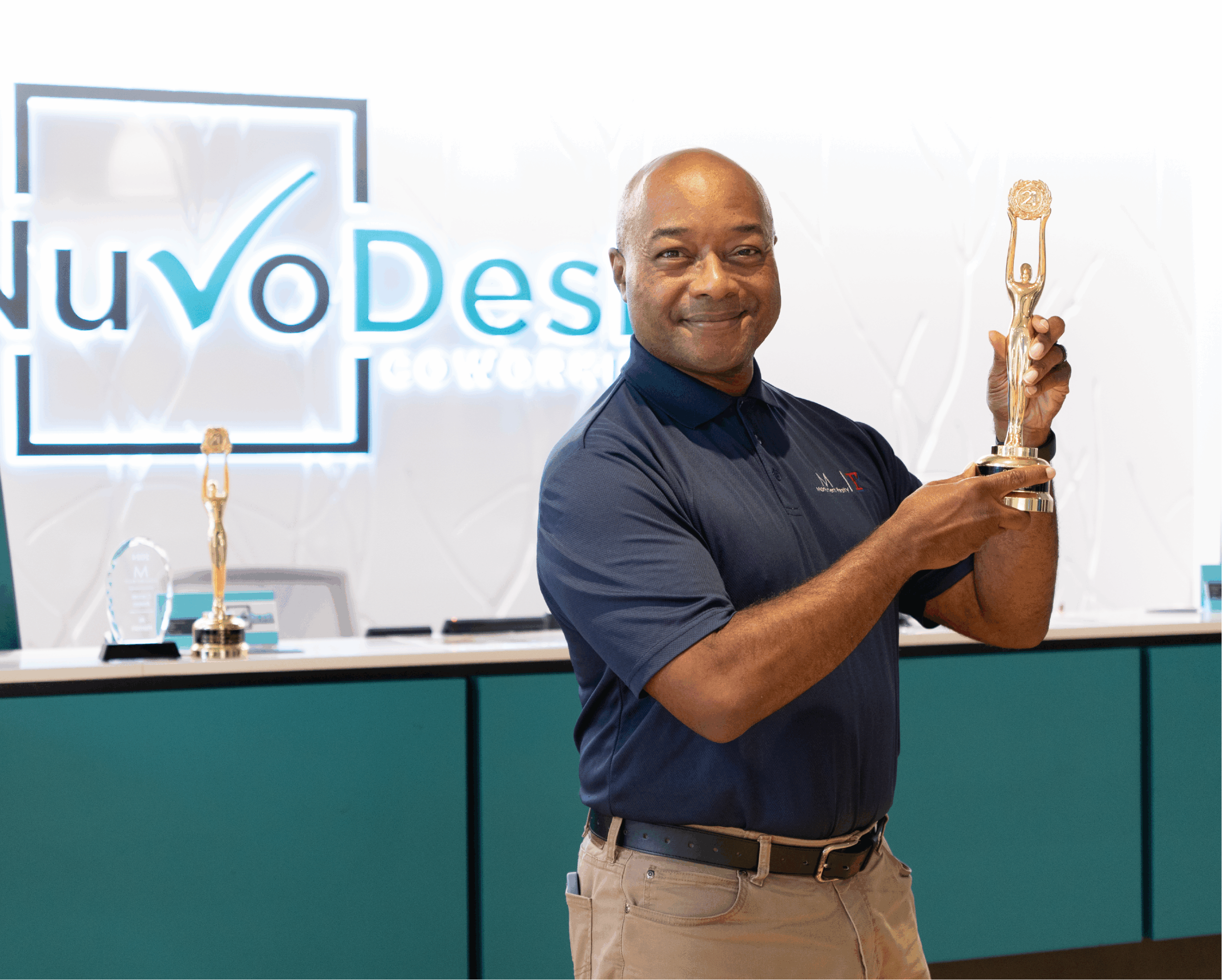 Al from Monument Realty holding award in NuvoDesk Coworking member spotlight