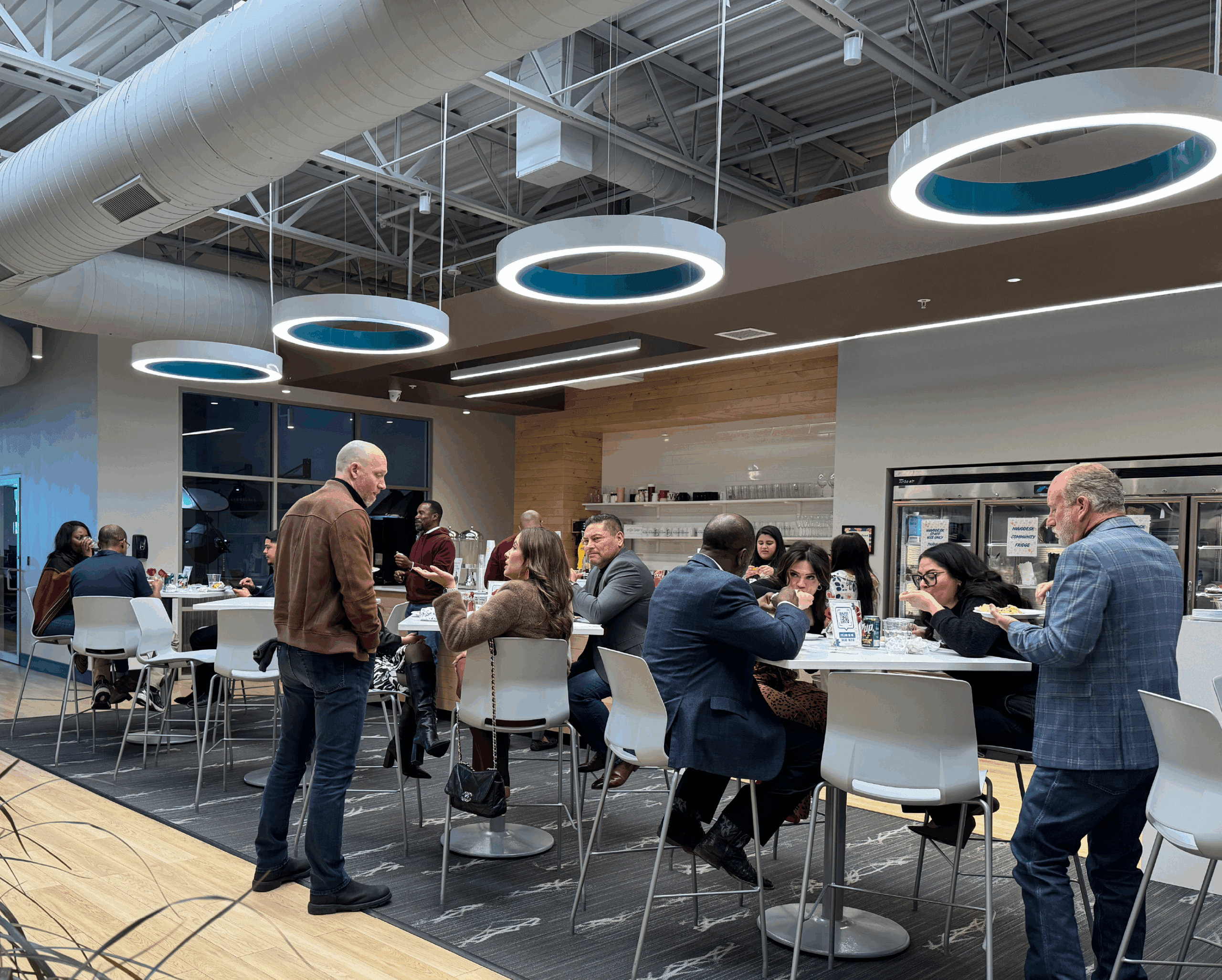 Networking Event at NuvoDesk Coworking ‣ NuvoDesk Coworking People networking and dining inside NuvoDesk coworking space